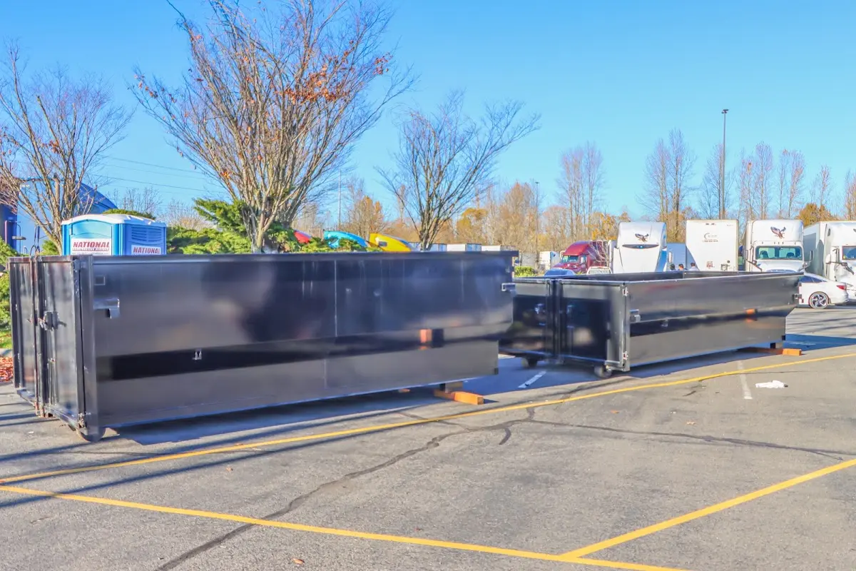 Professional dumpster rental service with roll-off container on residential driveway in Costa Mesa